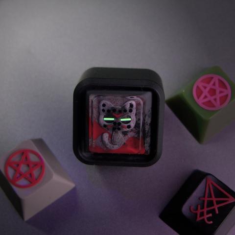 photograph of my new Jason Furball artisan keycap from Gothcaps, with my other Gothcaps artisans around it