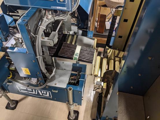 A bundle of nori sheets tied with a paper tape in a machine