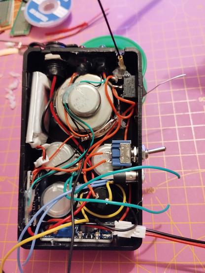 the open case filled with all components, except the main circuit board. almost all connections are done and a bit of hot glue keeps them in place