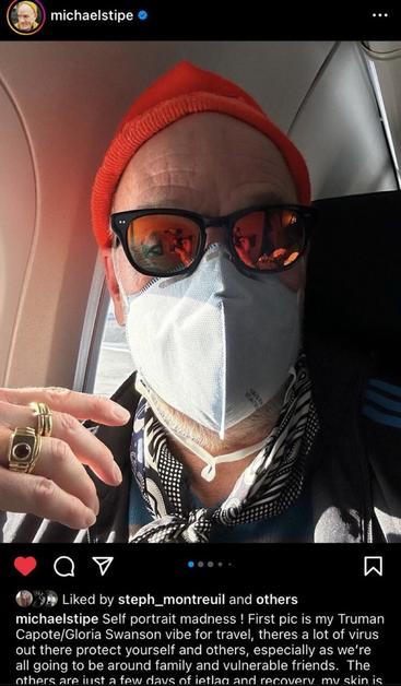 Michael Stipe wearing a respirator on a plane from an Instagram post