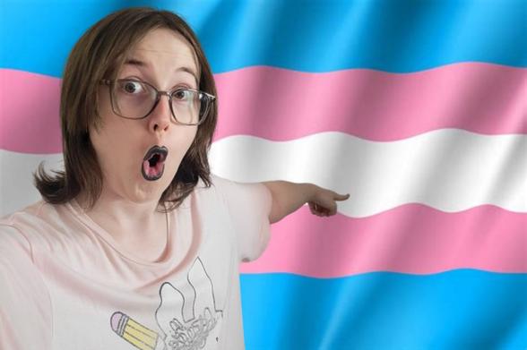 Selfie of Revy she is doing a poggers face and pointing backwards at the transgender flag