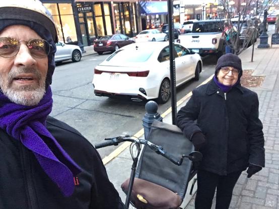 Obbie and Rozie stop for a selfie next to "The LImo" (a Double Vision tandem recumbent) in downtown La Crosse WI on a warm December afternoon.