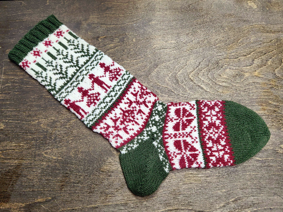 A green, red and white colorwork stocking. 

It is in the Norwegian style.