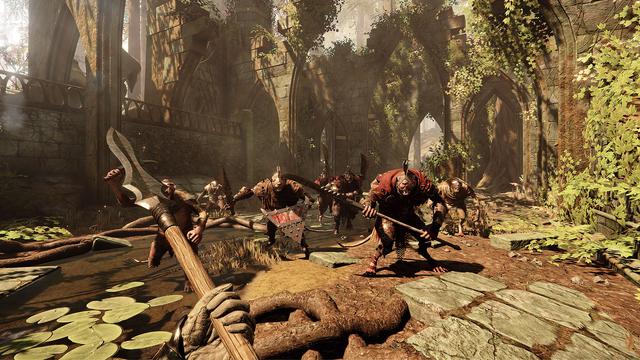 A first person view from the "Vermintide 2" video game. The player is wielding a spear and being charged by a group of 7 rats with various weapons and armor. The scene is taking place in an overgrown ruin.
