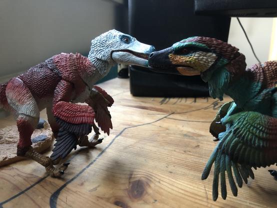 Two Beasts of the Mesozoic dinosaur toys like they’re sniffing one another’s snout.