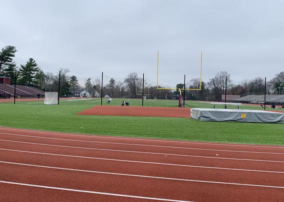 Two 13-year-old boys - they used to play together for the same club team - are kicking soccer balls at a high school turf field.