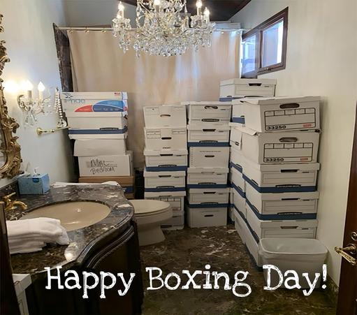 A photo. Boxes containing classified documents stacked to the ceiling in a Mar-A-Lago bathroom. The caption reads, "Happy Boxing Day"
