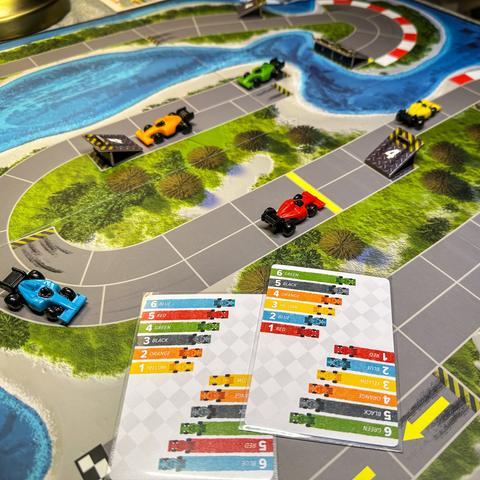 Photo of Downforce board game featuring small race cars on a track
