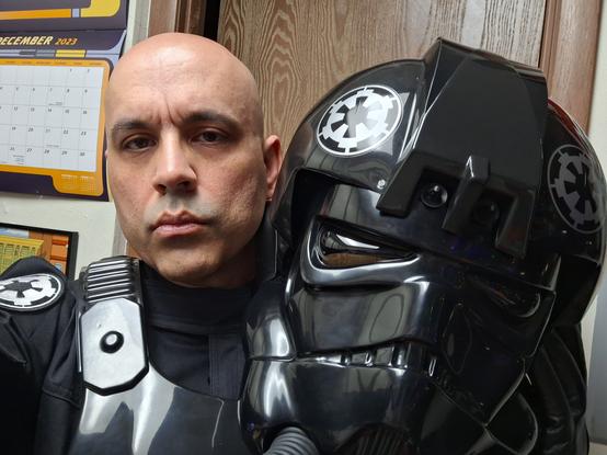 Yours truly in TIE pilot gear but I've removed the helmet so you can see that I'm either mildly tired or mildly annoyed