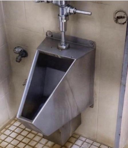A urinal looking a lot like the Tesla Cybertruck