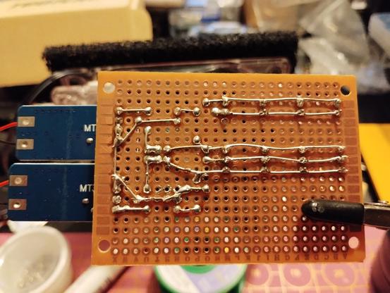backside of the finished perfboard. the soldering can be seen. I'm satisfied by how clean it looks.