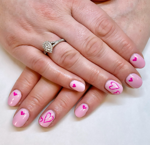 Sweety-pink nails with hot-pink hearts.