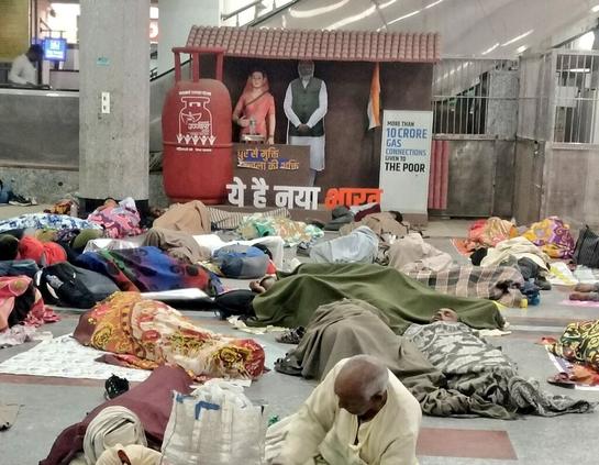 Selfie point with 3D avatar of Indian PM Narendra Modi, where dozens of homeless are sleeping
