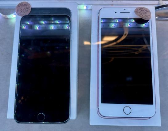 iPhone 6S Plus and 7 Plus in an antique store display.