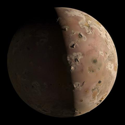 Half lit image of the Jupiter Moon Io showing a mostly brownish surface. Sharp mountains stand out against the otherwise smooth surface and cast long shadows along the terminator line. Black lava flows are scattered around on the surface.
The shadowed side of the moon is dimly lit by Jupiter and was slightly brightened during processing. 

Credit: NASA / JPL-Caltech / SwRI / MSSS / Simeon Schmauß