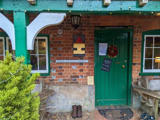 entrance to an old-style country pub "The Black Horse" near Checkendon, Oxfordshire, England. January 2024