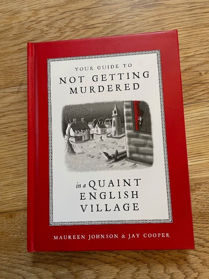 Cover of the book "Your Guide to Not Getting Murdered in a Quaint English Village" by Maureen Johnson and Jay Cooper. 
Cover is red with a white panel featuring an image of the legs of someone who's croaked it protruding from the side of a house in a quaint English village.