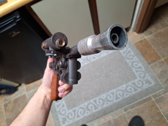 Front isometric view of a replica DL44 blaster with a good view of the muzzle detail and a better look at the front of that giant scope
