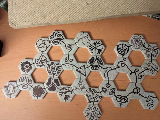 Several hexagonal tiles placed in a honeycomb pattern so that continuous lines appear to move across tiles, through the designs on the tiles.