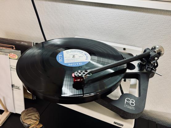 Photo of a record spinning on the skeletal frame of a Rega P8 turntable. 

The centre label reads, ‘Blue Note’.