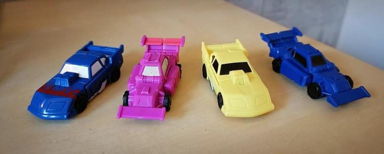 The four in car modes. The cheapness of the modern remakes is most visible here as we have only two molds between four toys: MotorHead and Runner are redecos of GroundHog and Roller Force respectively. Notably the redecos have fewer paint apps as well. Tsk.