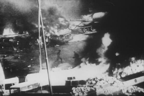 Barricades and Soviet tanks on fire during the Warsaw Pact invasion of Prague. By National Archives (archive.org) - https://archive.org/details/gov.archives.arc.1536420, Public Domain, https://commons.wikimedia.org/w/index.php?curid=31502243