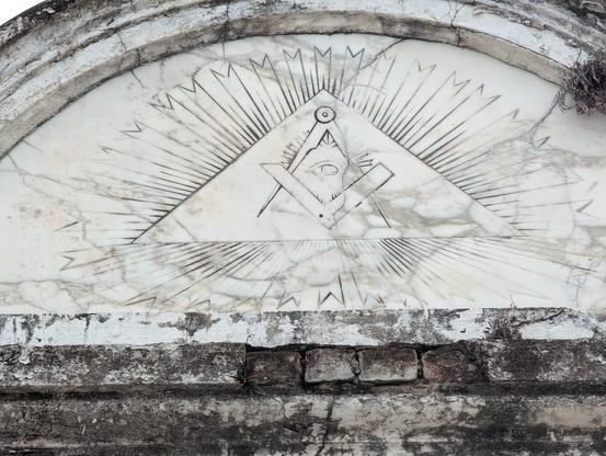 The Loggia Dante masonic lodge tomb in the St Louis 3 cemetery in Storyville, New Orleans.

A detail of the Masonic sigil over the top of the tomb.
