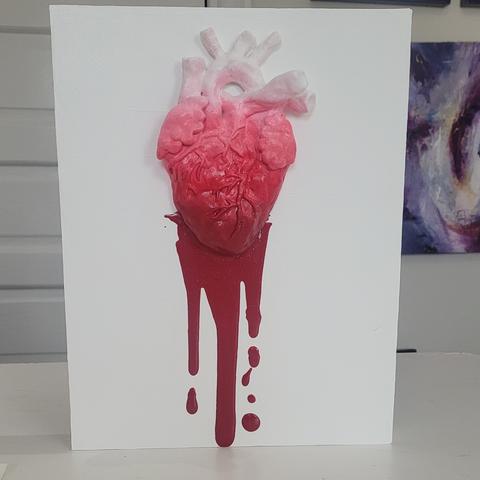 Photo of a 3 dimensional painting of an anatomical heart with blood red drops