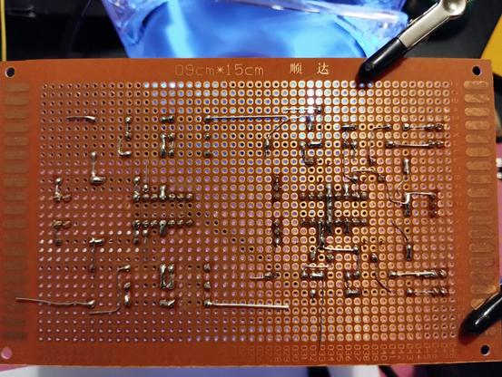 the back side of the perfboard showing my soldering. a few resistor legs are not clipped yet, because they will be used to make connections to not yet placed components