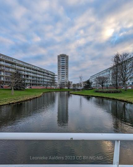 Stream surrounded by apartment buildings