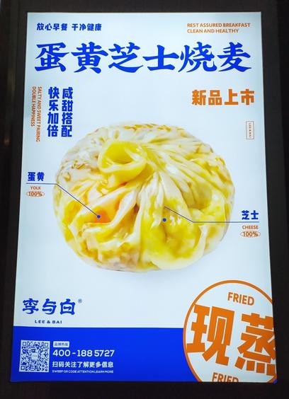 A sign advertising freshly steamed Shanghai-style shaomai sticky-rice dumpling with salted egg yolk and cheese.