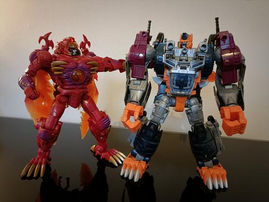 Megatron (left) welcomes his old sparring partner, Optimal Optimus (right), with a friendly arm. Optimus looks weirded out by this. He should. Double-Megatron is NASTY.

Even without the third-party add-on pieces this Optimal toy is wearing it's quite striking how much bulkier he is despite being a leader class figure like Megatron. But then Megs does have those amazing wings folded away...