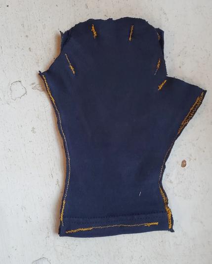 A fingerless glove stitched out together from rags. The bottom.