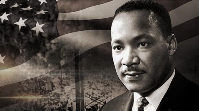 Monochrome image of Dr. Martin Luther King, Jr. with US flag background.