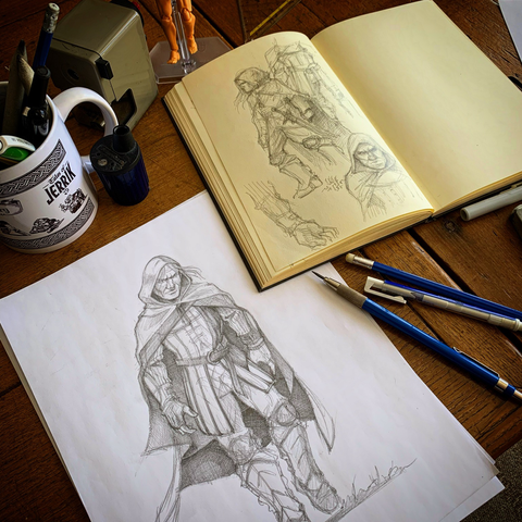 A hand drawn pencil sketch of a mysterious character with some sketchbook concept doodles for reference.