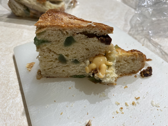 Slice of three kings cake with almost half of the baby showing
