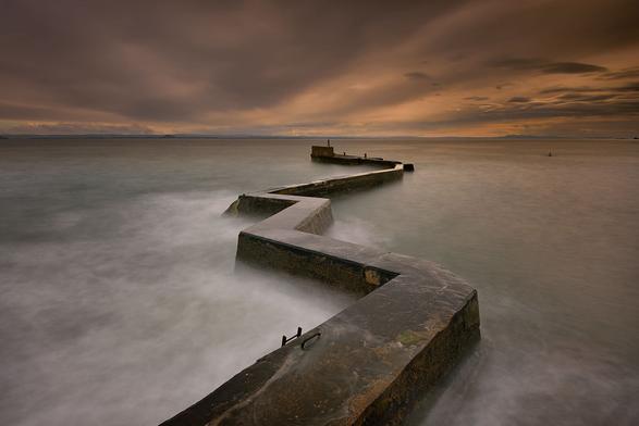 Zig and zag - A dark and ominous sky over the Firth of Forth provides the ideal moody backdrop to a long exposure of 'The blocks', the iconic zig zag breakwater on the outer harbour wall at St Monans.

Although conditions were fairly rough at the time with waves frequently crashing over the breakwater, the long exposure paints a deceptive sense of calm of the turmoil below.

St Monans, East Neuk of Fife, Scotland
 

<a href="http://www.twiston.com/" rel="noreferrer nofollow"><b>website</b></a> | <a href="https://www.instagram.com/images.twiston/" rel="noreferrer nofollow"><b>instagram</b></a> | <a href="https://500px.com/p/twiston?view=photos" rel="noreferrer nofollow"><b>500px</b></a>