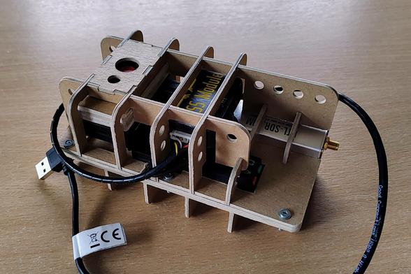 assembled FlightBox: Raspberry Pi Zero, GNSS module, USB hub, soundcard stick, RTL-SDR stick and 10000 mAh powerbank held together by a cardboard skeleton case