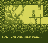 Screenshot from Feed IT Souls by Gumpy Function, the nameless protagonist is standing in a cave before the titular monster IT, who shows an unimpressed face on its screen and says "Wow,  you can jump now..."