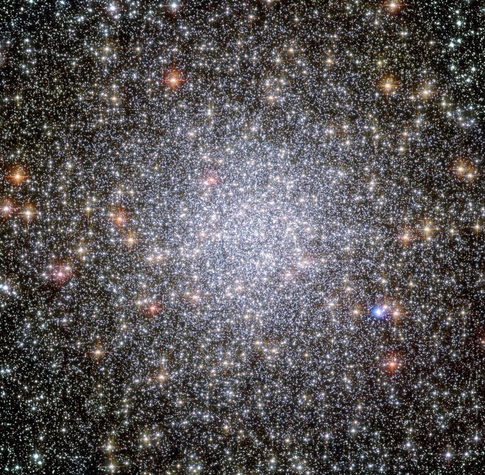 Astrophotograph of a very dense star field with the central core region of the image showing a collection of white, bright stars in spherical configuration.