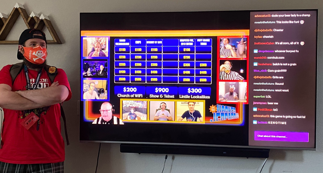 Image of a masked goon running the board for our socially distanced version of hacker jeopardy during DEF CON Safe Mode