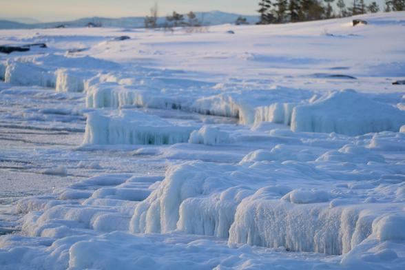 Rocks caked in ice that has a blue shine to it