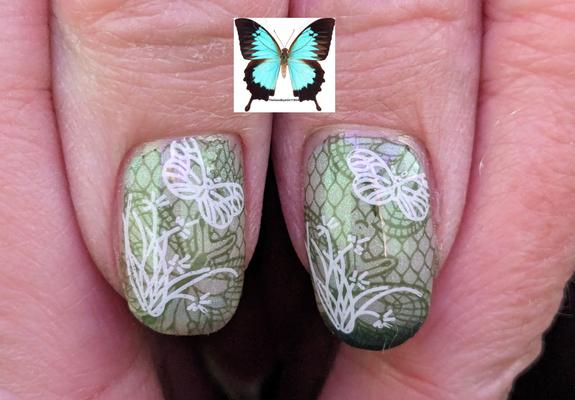 Two thumbs with a white base and green line butterfly stamping with white leaves stamped as well as a butterfly.