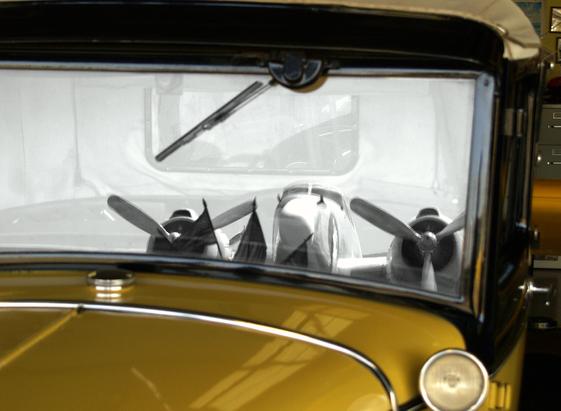 Reflection On The Past

This is an image of a Ford Model A captured inside a hangar at Nut Tree Airport in Vacaville. 
The paint is a deep yellow that shines flawlessly. There are many chrome accents on the car including the radiator cap, trim around the headlamp and other places.
The window is framed in black painted steel and a windshield wiper hangs down from the frame above. 
I converted the portion of the image inside the window frame to black and white. 
The reflection in the window is an old, restored C47.  Two of the engines with their propellers can be seen in the window along with the front of the fuselage.