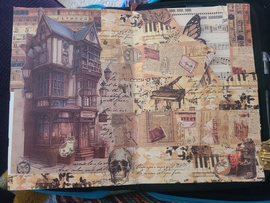 A two page layout in a journal, covered in vintage-vibes paper and a ton of vintage-themed washi tape. There are some layers of paper here, and and cutouts revealing projects on the next page. Cat stickers are speckled across as well.