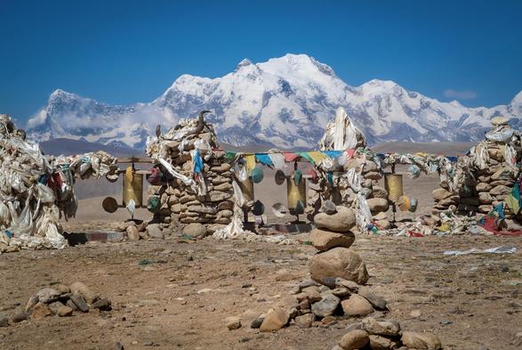 photo - shrine with snow capped mountains in the back, Tibet