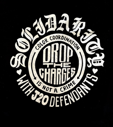 A design reading "Solidarity with J20 defendantss—Drop the charges—color coordination is not a crime"