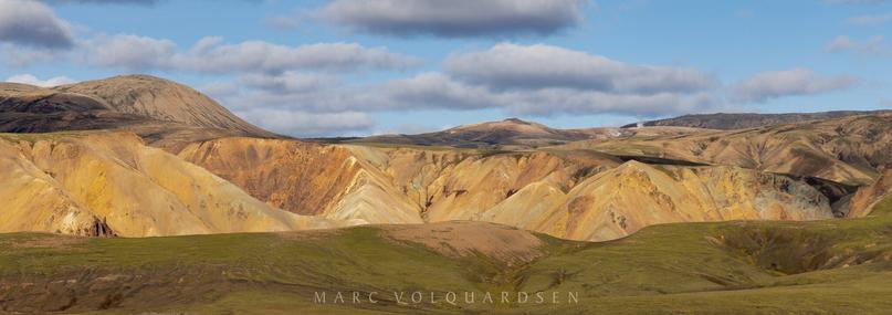 View into rhyolite mountains - fumaroles steaming at the top right