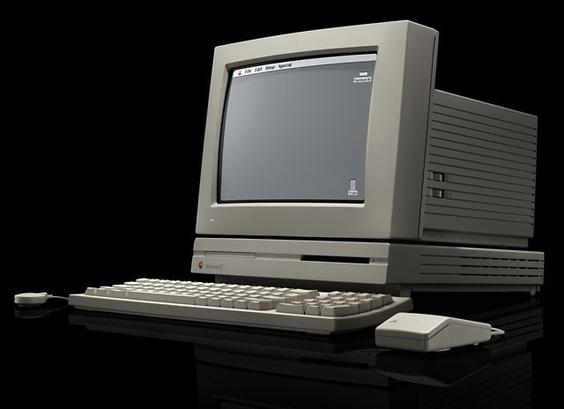Apple Macintosh LC desktop computer with 12 inch CRT monitor, mouse, and microphone
