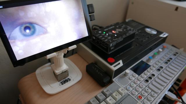 Big eye on a small monitor and various keyboards and synths. Hipster as fuck, really.